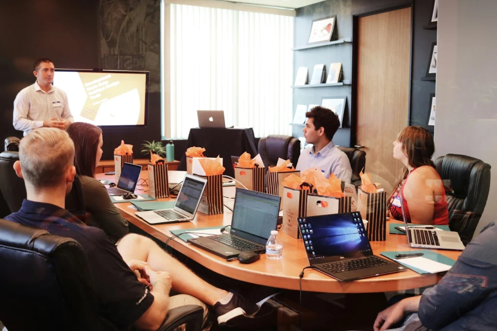 A group of workers sat around an office table for a meeting.