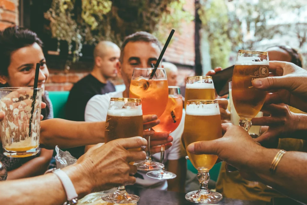 A group of friends toasting a drink in a pub.